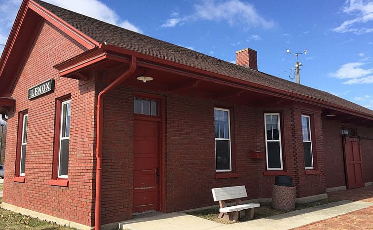 Exterior of the historic Lenox Depot, a red brick building with a matching red door and roofline